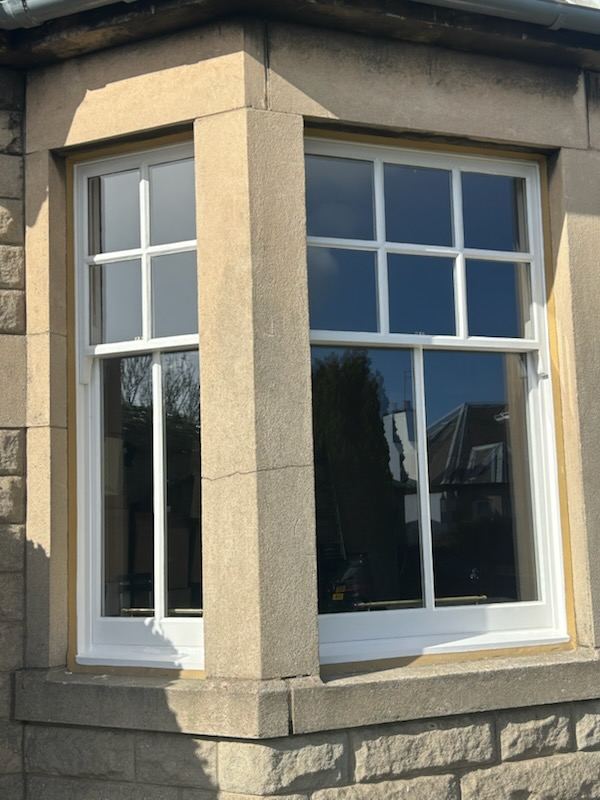 Portobello bay window after restoration, showing crisp paintwork and slimline double-glazed sashes.