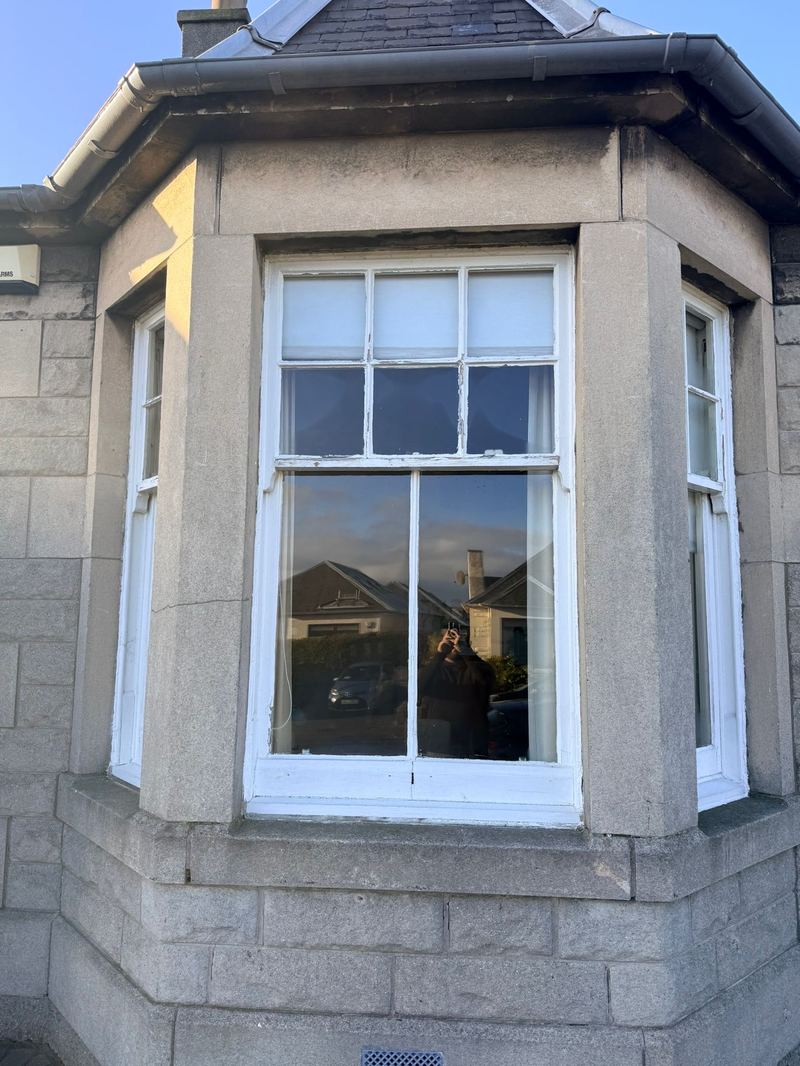Close-up of decayed sash and tired paintwork on the Portobello bay window.